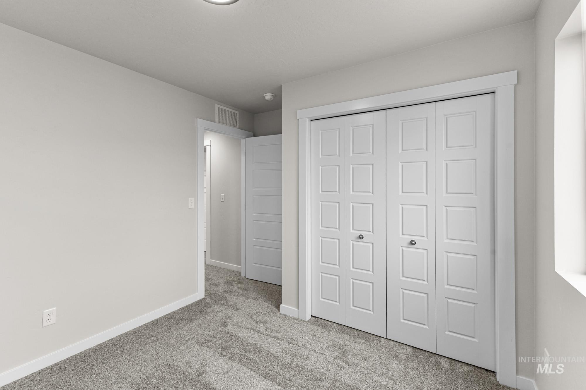10467 West Tinder Street Star, ID 83669 - Photo 15 of 20 Unfurnished bedroom featuring light colored carpet and a closet