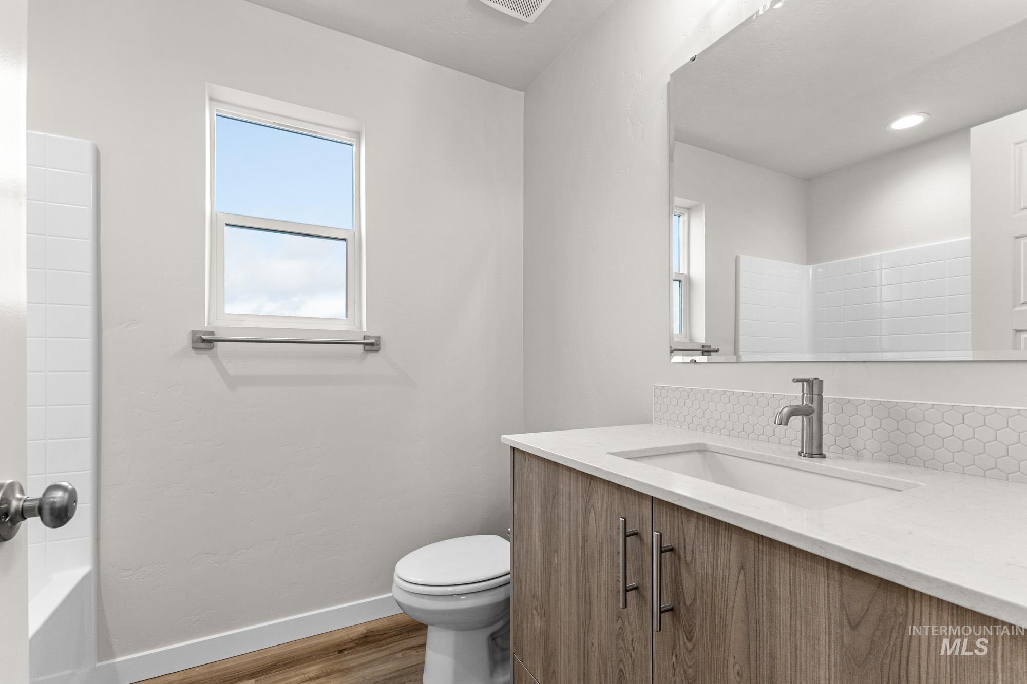 10467 West Tinder Street Star, ID 83669 - Photo 17 of 21 Bathroom with vanity, light wood finished floors, and shower / tub combination