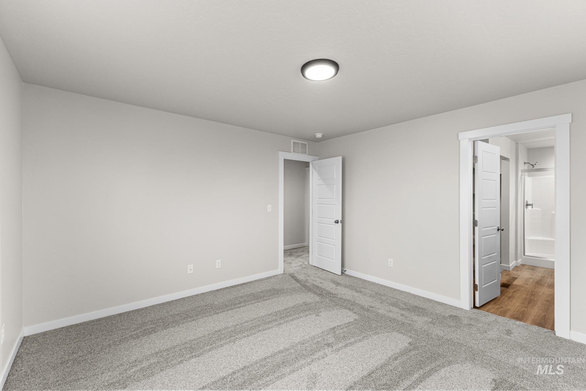 10467 West Tinder Street Star, ID 83669 - Photo 18 of 20 Unfurnished bedroom with light carpet and connected bathroom