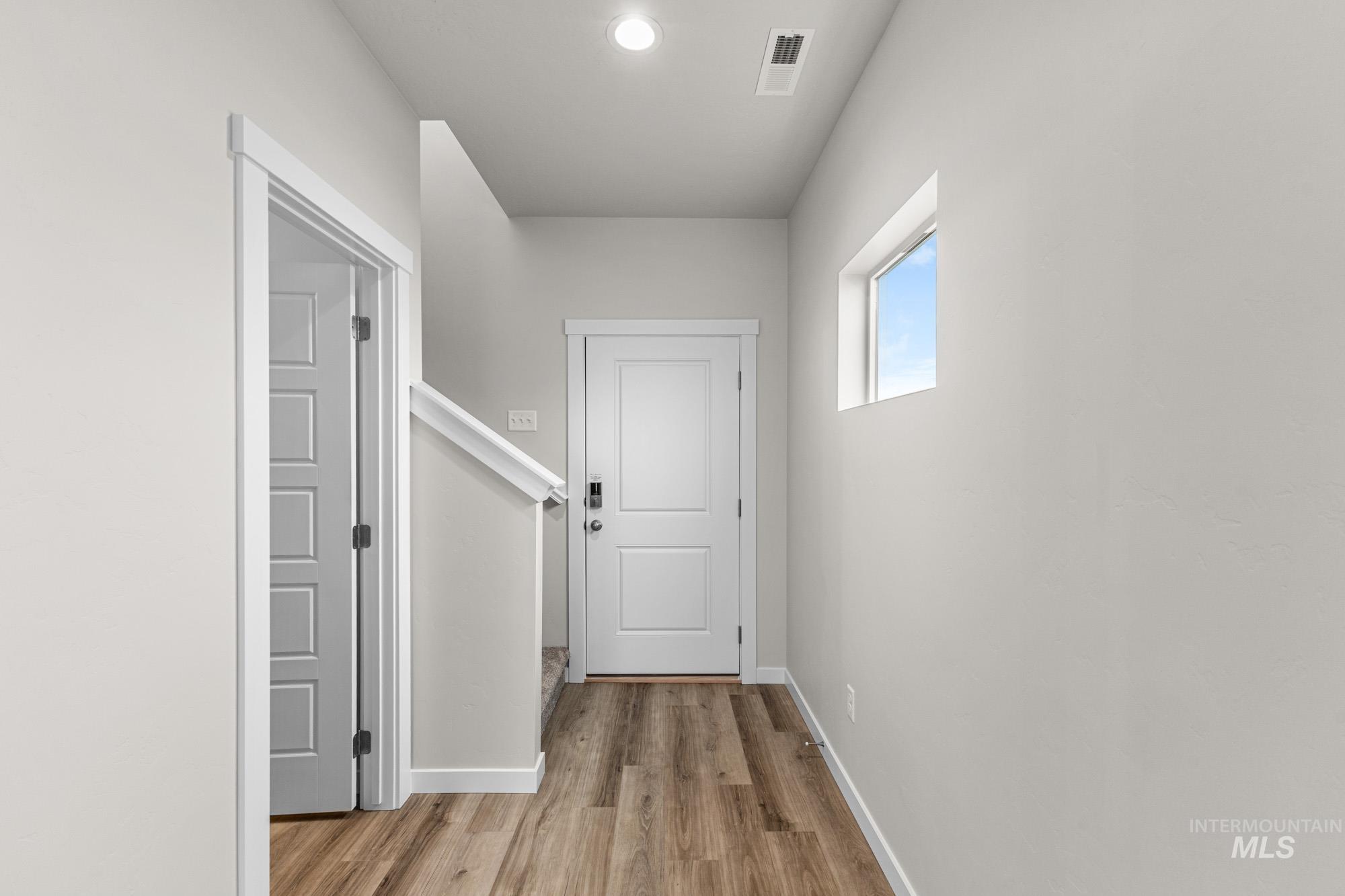 10467 West Tinder Street Star, ID 83669 - Photo 3 of 21 Hall with light wood-style flooring and baseboards