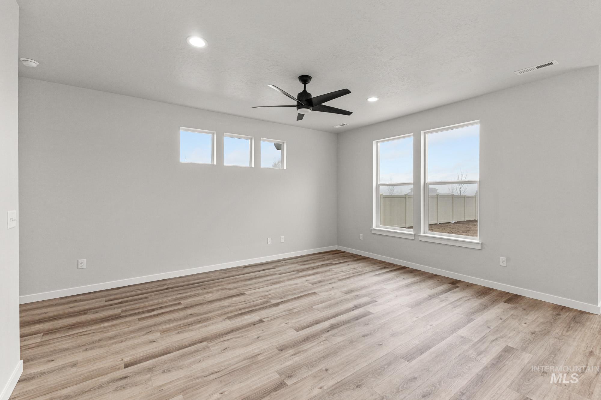 10467 West Tinder Street Star, ID 83669 - Photo 9 of 21 Spare room with light wood-style floors, a ceiling fan, plenty of natural light, and recessed lighting