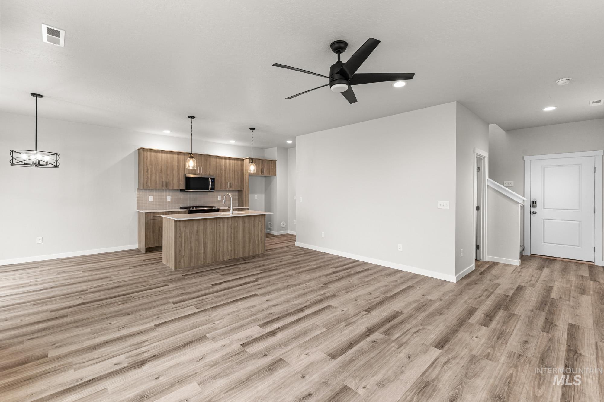 10467 West Tinder Street Star, ID 83669 - Photo 9 of 20 Unfurnished living room featuring ceiling fan, recessed lighting, and light wood-type flooring