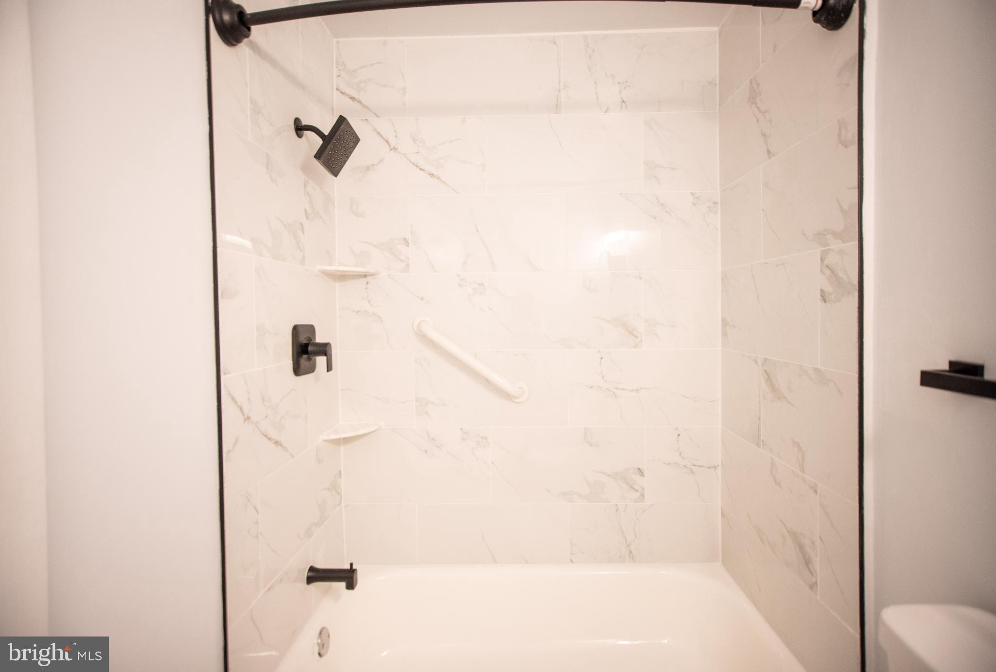 13408 Shady Knoll Drive, Unit 308 Silver Spring, MD 20904 - Photo 15 of 21 Sleek modern shower with elegant marble tiles.