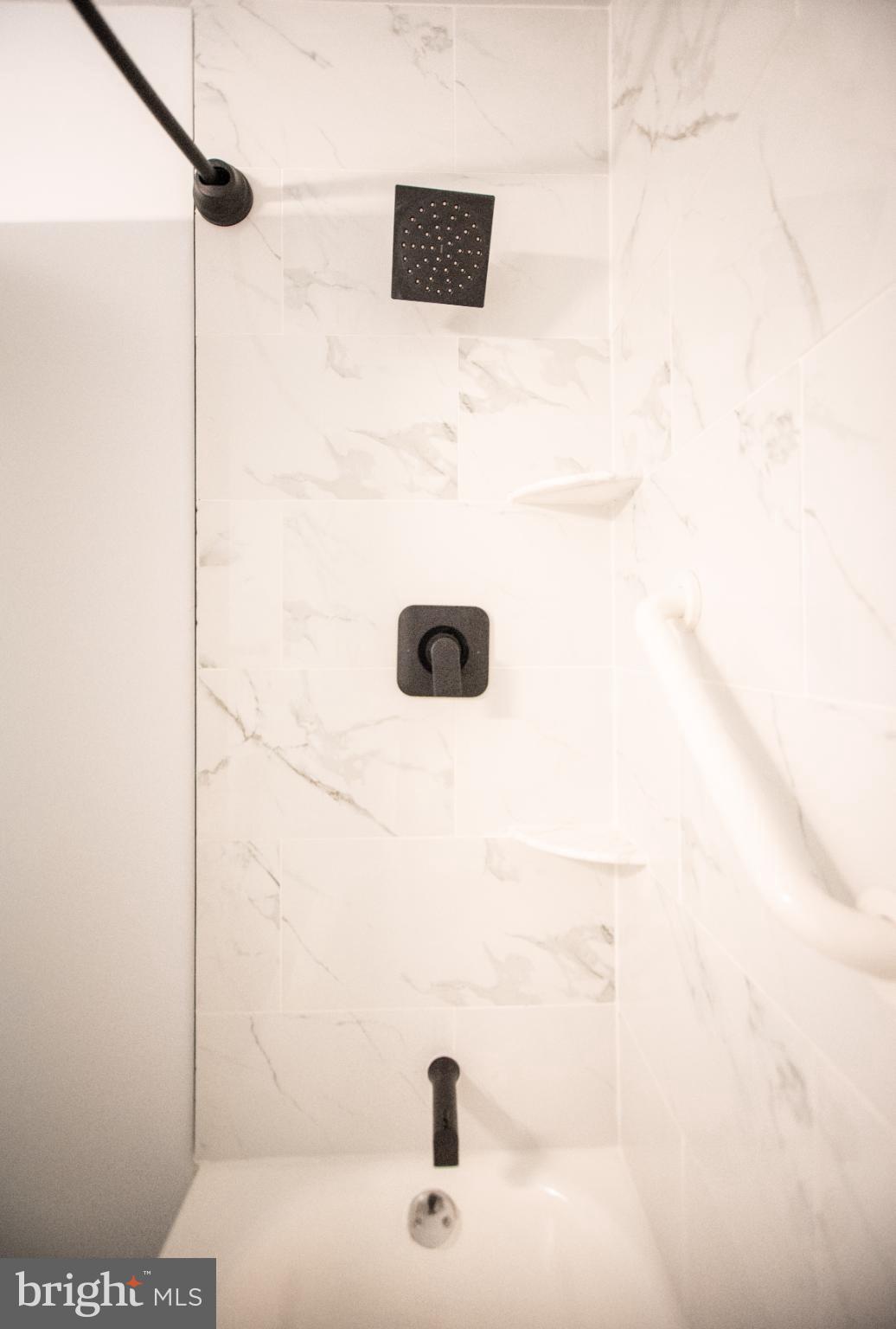 13408 Shady Knoll Drive, Unit 308 Silver Spring, MD 20904 - Photo 16 of 21 Sleek shower design with elegant marble tiles.