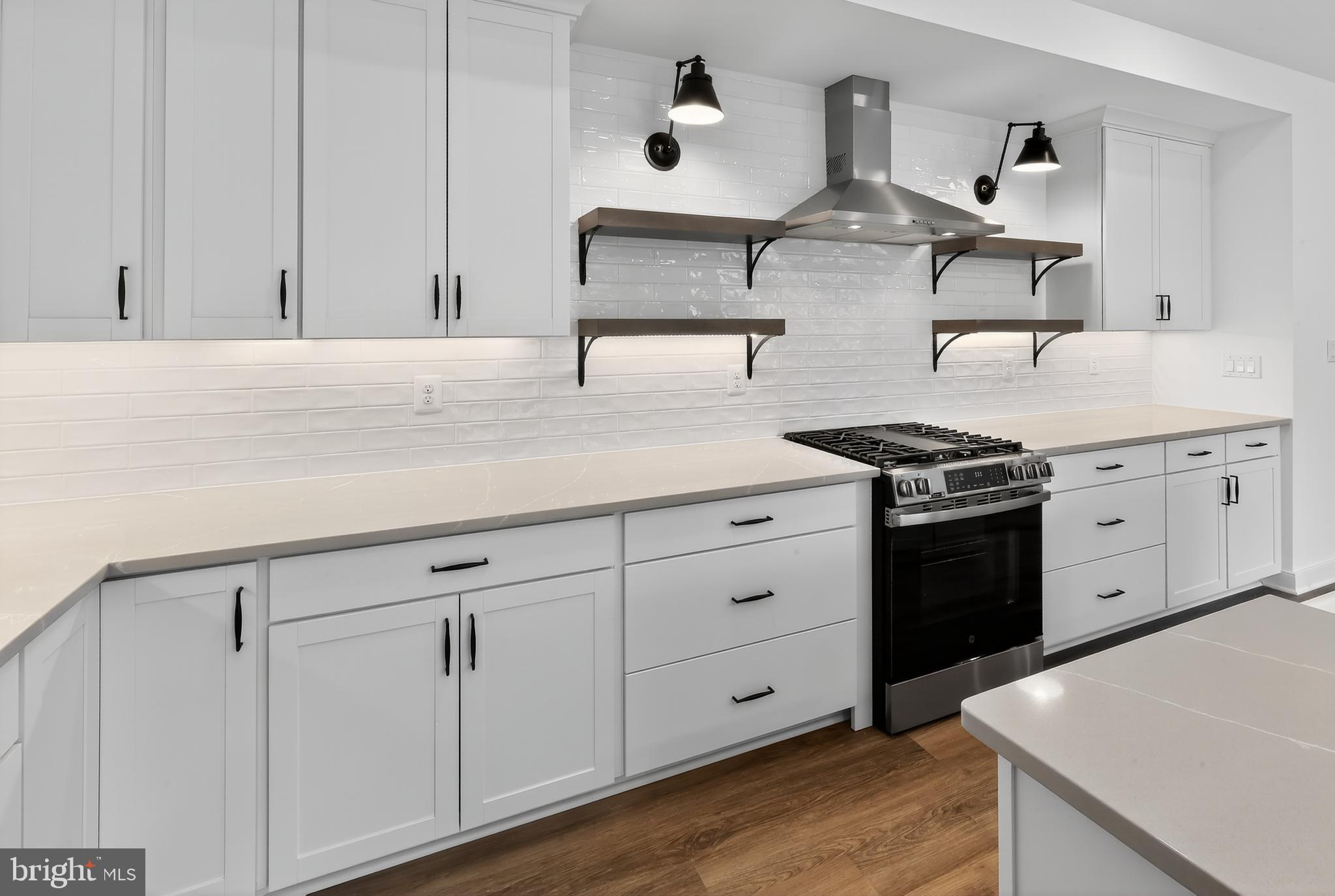 36444 Maple Ridge Lane Georgetown, DE 19947 - Photo 3 of 29 a kitchen with stainless steel appliances granite countertop white cabinets and a sink