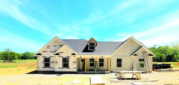 a view of a big house with wooden fence