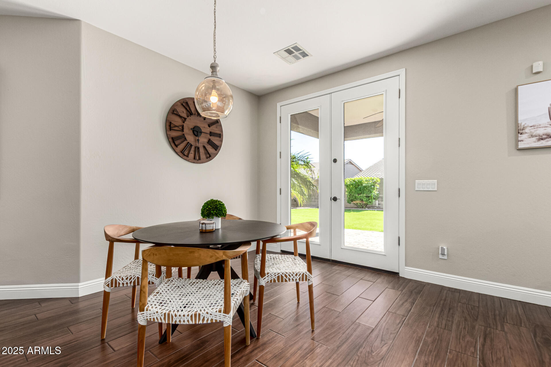 11411 East Sebring Circle Mesa, AZ 85212 - Photo 13 of 87 a dining room with furniture and wooden floor
