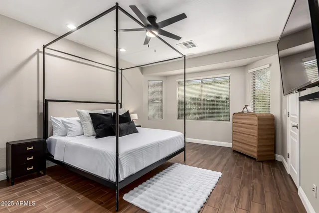 a bedroom with a bed and a flat screen tv