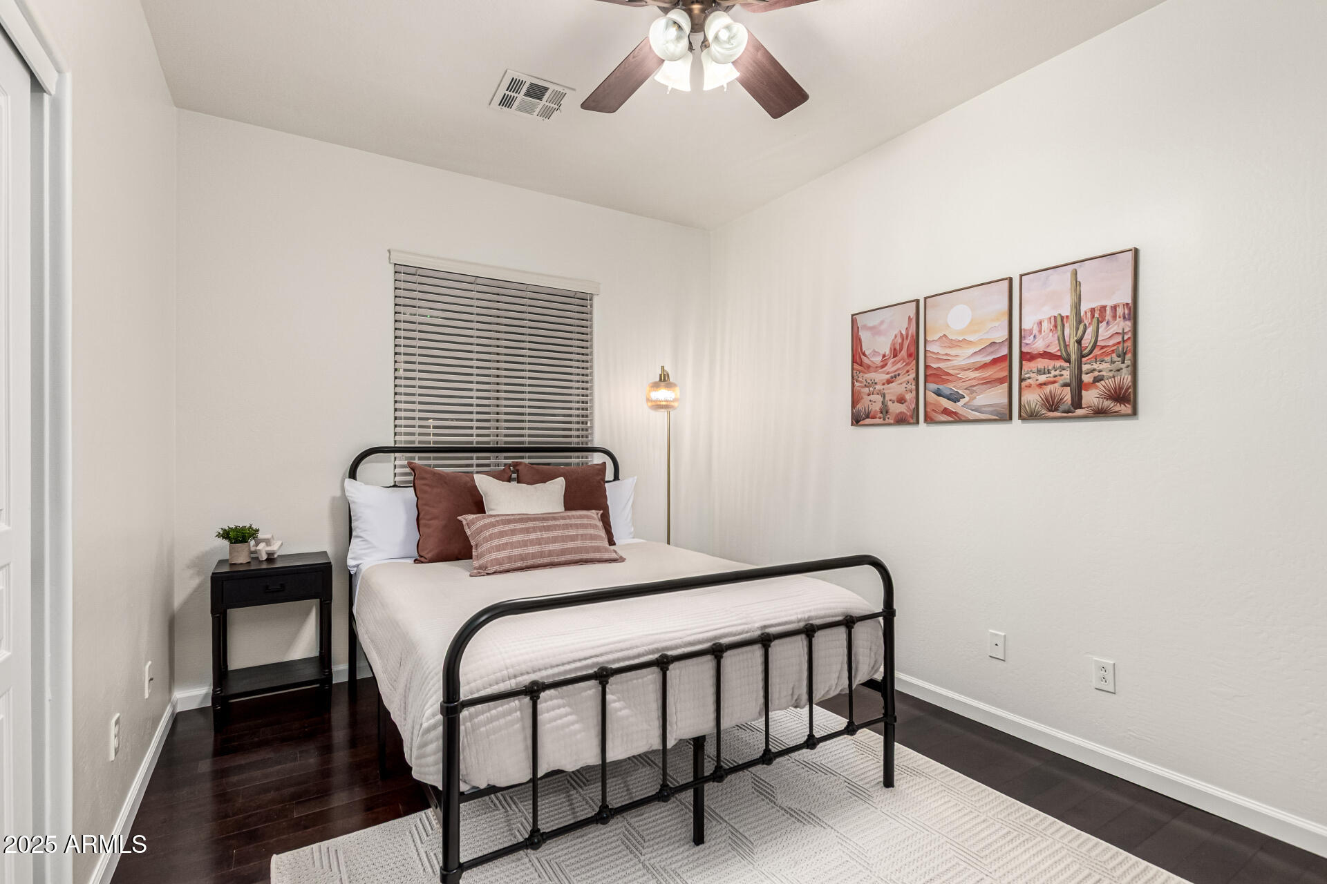 11411 East Sebring Circle Mesa, AZ 85212 - Photo 26 of 87 a bedroom with a bed and a painting on the wall