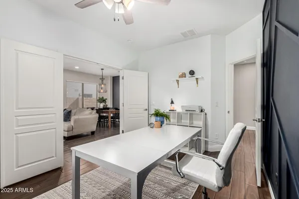 a kitchen with stainless steel appliances a refrigerator and wooden floor
