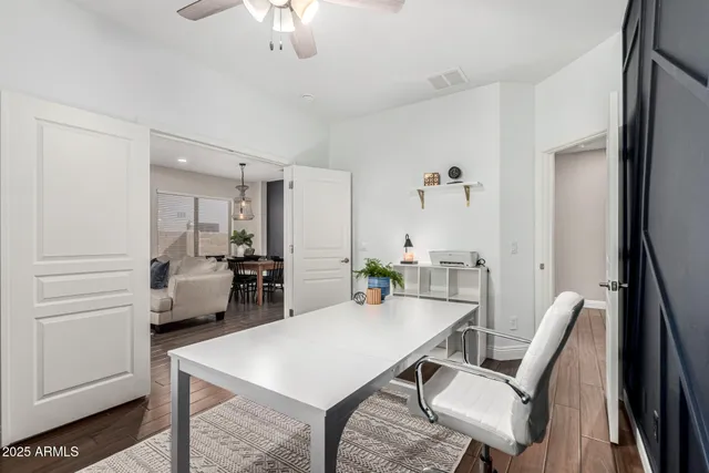 a kitchen with stainless steel appliances a refrigerator and wooden floor