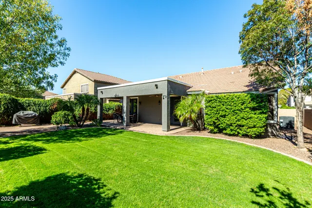 a view of a house with a yard and potted plants