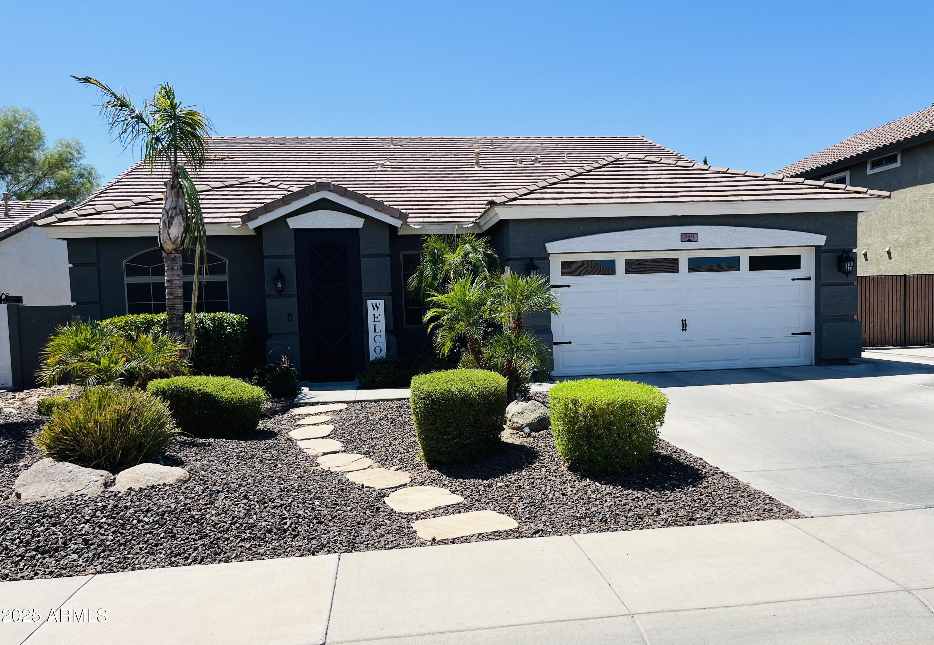 11411 East Sebring Circle Mesa, AZ 85212 - Photo 40 of 87 a front view of a house with garden