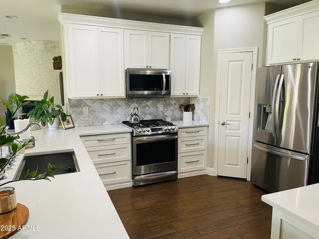 a bedroom with a bed a table and window