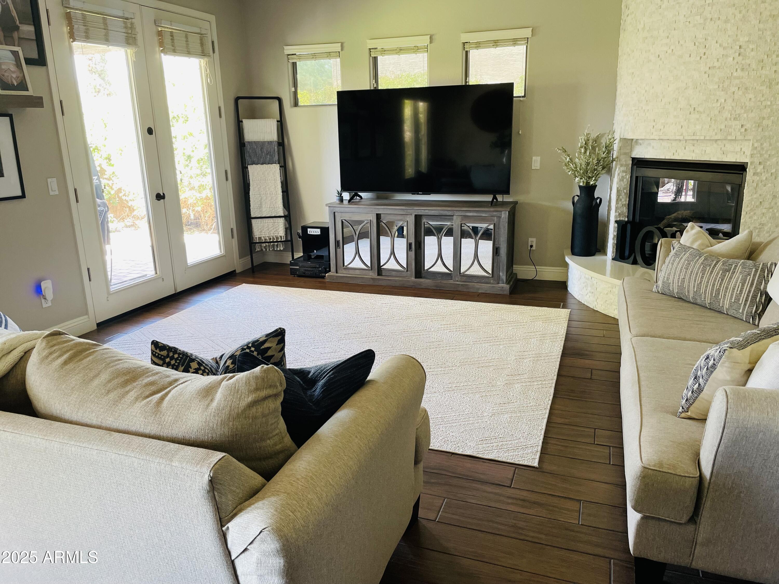 11411 East Sebring Circle Mesa, AZ 85212 - Photo 60 of 87 a living room with furniture and a flat screen tv