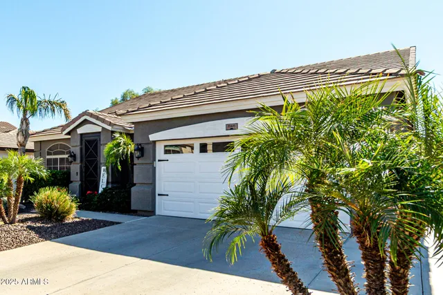 a view of a dining room with furniture wooden floor and a chandelier