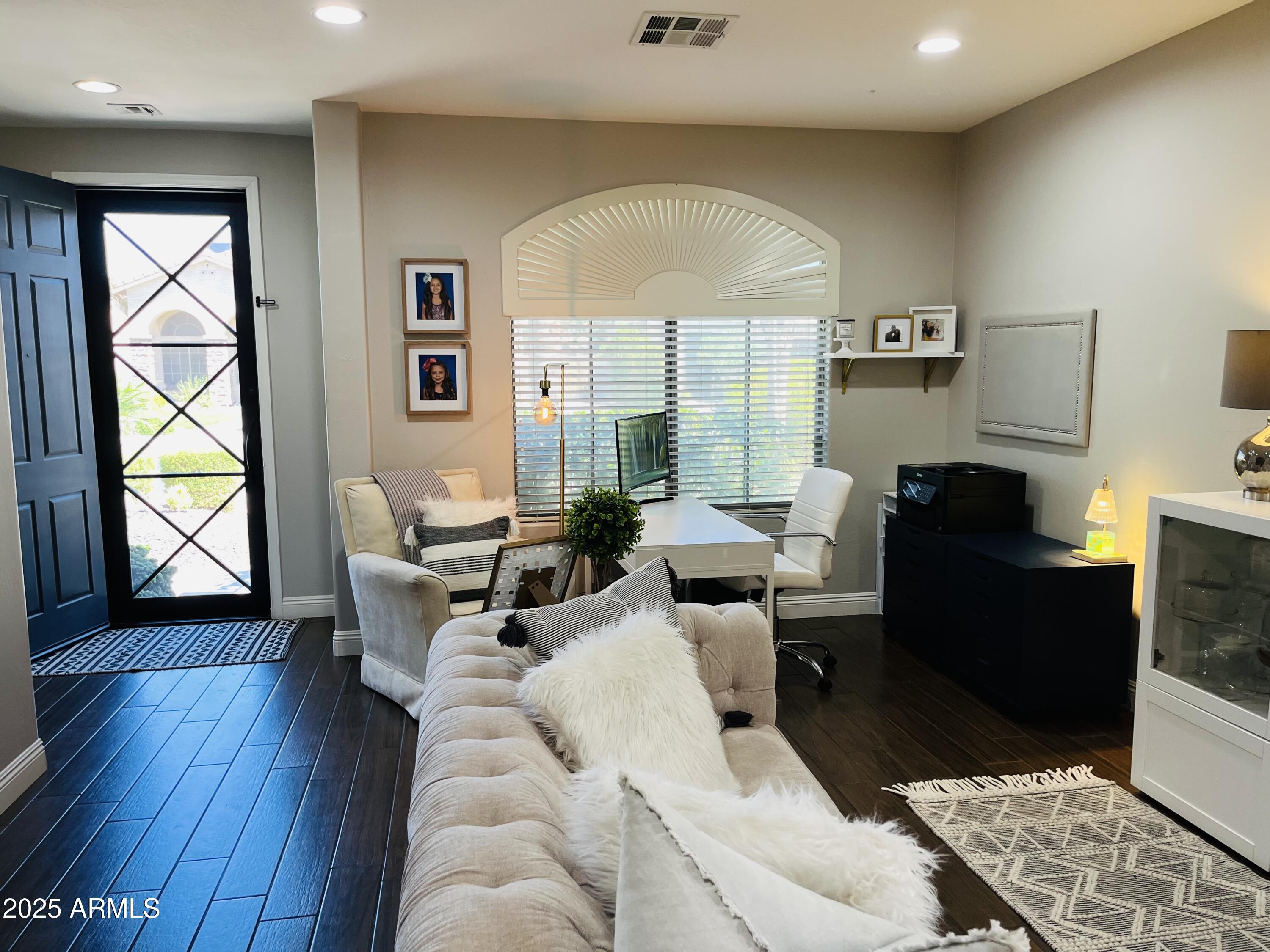 11411 East Sebring Circle Mesa, AZ 85212 - Photo 75 of 87 a living room with furniture a window and wooden floor