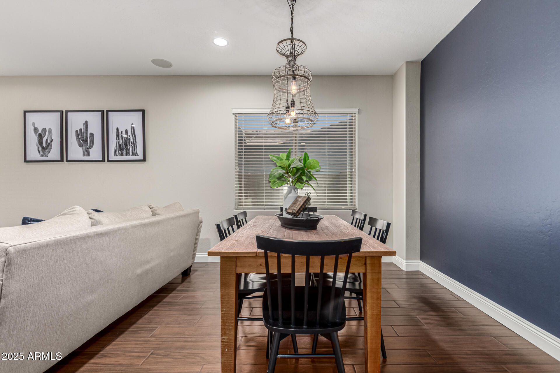 11411 East Sebring Circle Mesa, AZ 85212 - Photo 9 of 87 a view of a dining room with furniture wooden floor and a chandelier