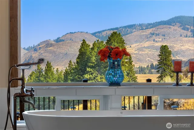 a bedroom with a bed and a large window