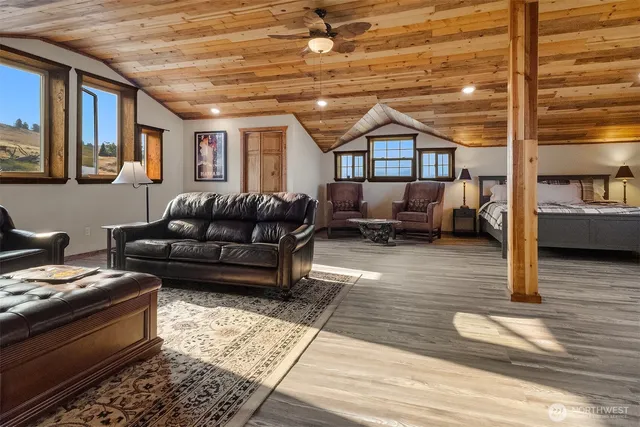 a view of a hallway with wooden floor and entryway
