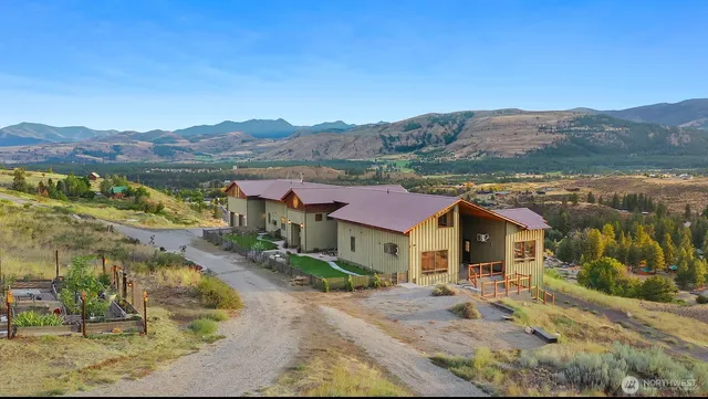 a view of a house with a big yard couches and large trees