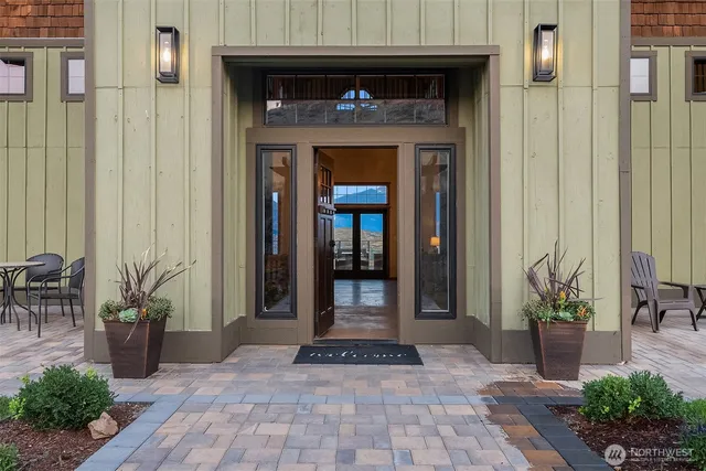 a front view of a house with potted plants