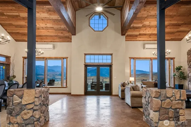 a living room with furniture and large windows