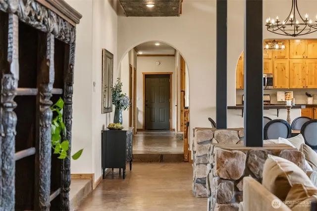 a living room with furniture and a chandelier