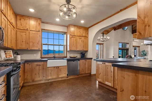 a kitchen with stainless steel appliances granite countertop a sink and cabinets