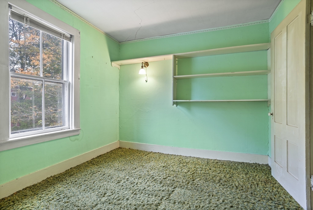 2 Maple Street Shirley, MA 01464 - Photo 24 of 35 a room with a window and a wooden cabinets