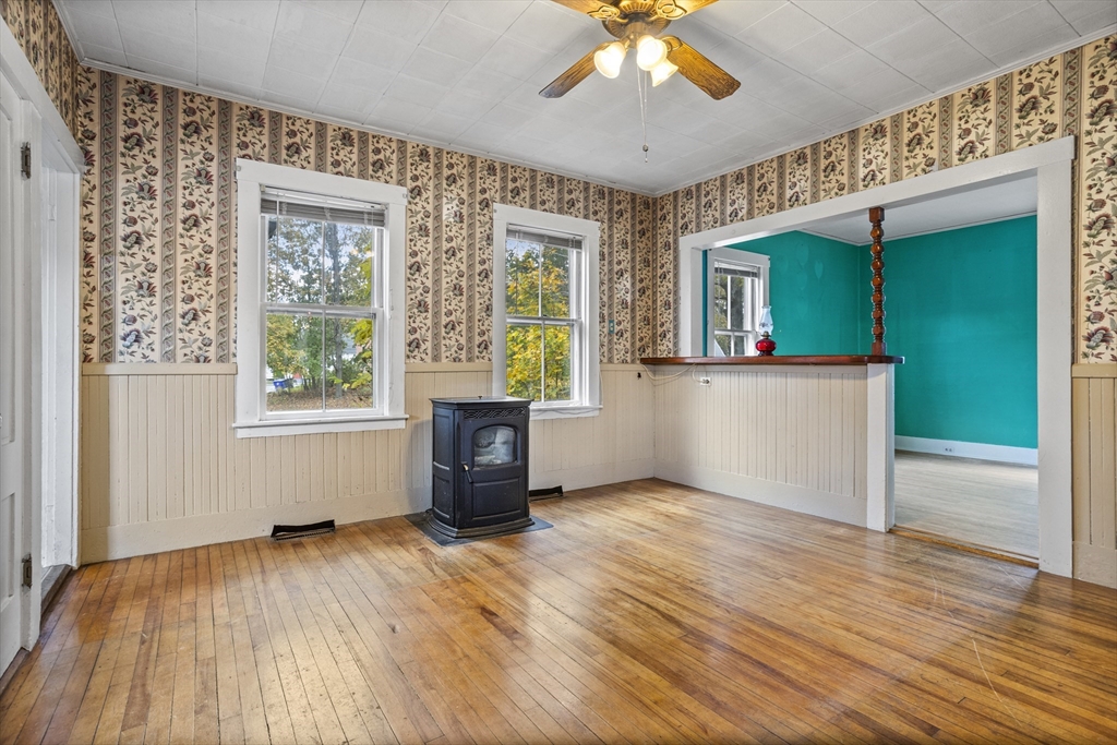 2 Maple Street Shirley, MA 01464 - Photo 3 of 35 an empty room with wooden floor fan and windows
