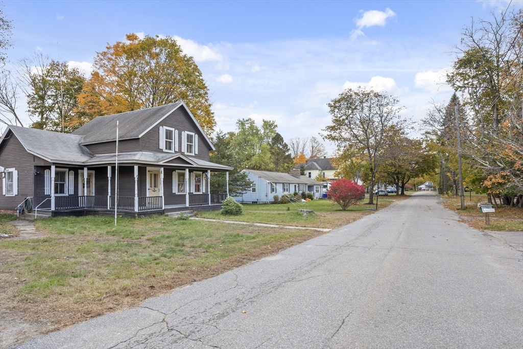 2 Maple Street Shirley, MA 01464 - Photo 7 of 35 a front view of a house with a garden and trees