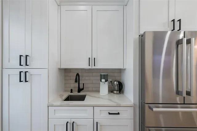a bedroom with a bed and a flat tv screen on dresser