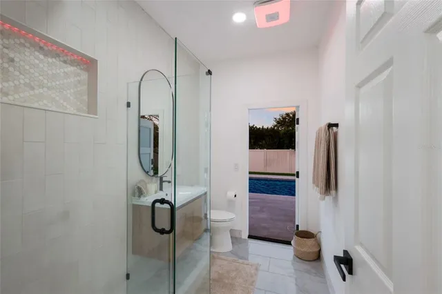 a spacious bathroom with a bathtub shower sink mirror and toilet