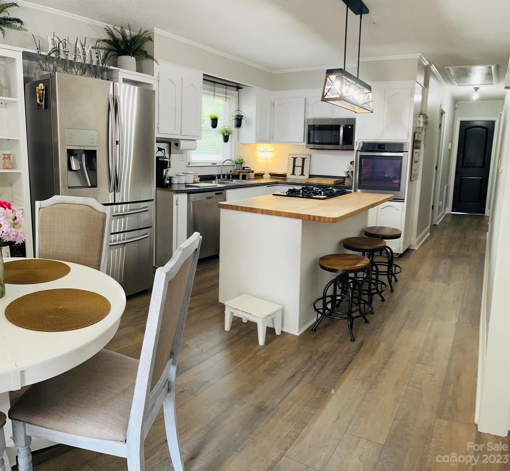 3001 Beaty Road Gastonia, NC 28056 - Photo 12 of 15 a kitchen with sink refrigerator dining table and chairs