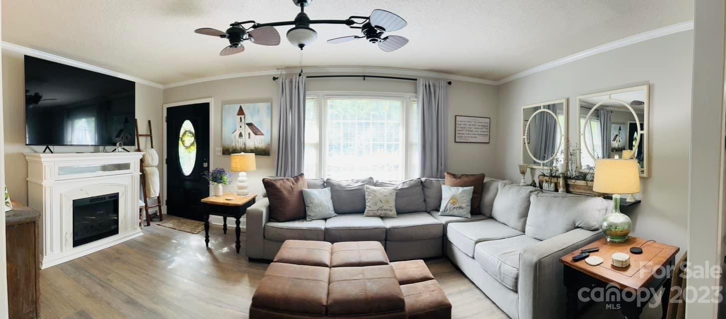 3001 Beaty Road Gastonia, NC 28056 - Photo 13 of 15 a living room with furniture a flat screen tv and a fireplace