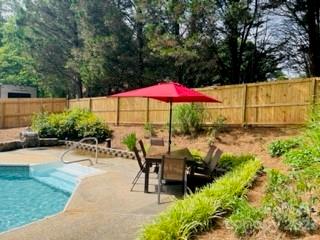 3001 Beaty Road Gastonia, NC 28056 - Photo 4 of 15 a view of a patio with chairs under an umbrella