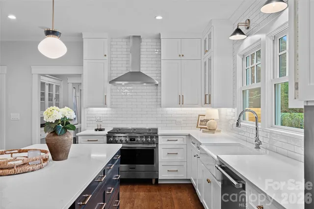 a kitchen with a stove sink and a granite counter tops