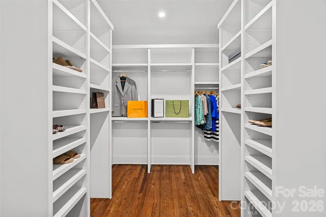 a view of walk in closet with empty racks