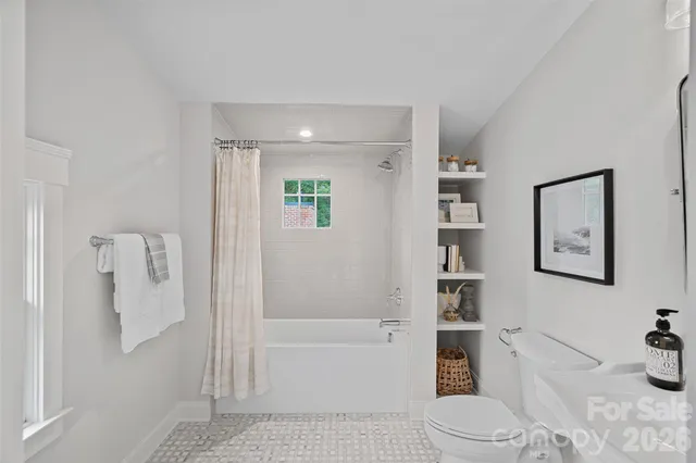 a bathroom with a toilet a sink and bathtub