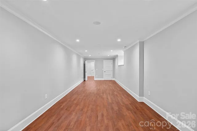 a view of a big room with wooden floor and natural light