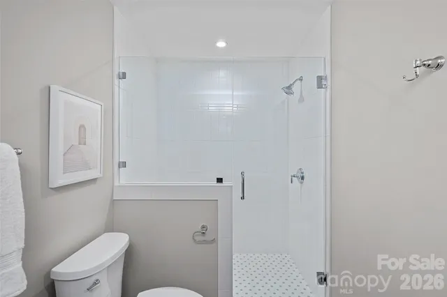 a bathroom with a toilet and a shower