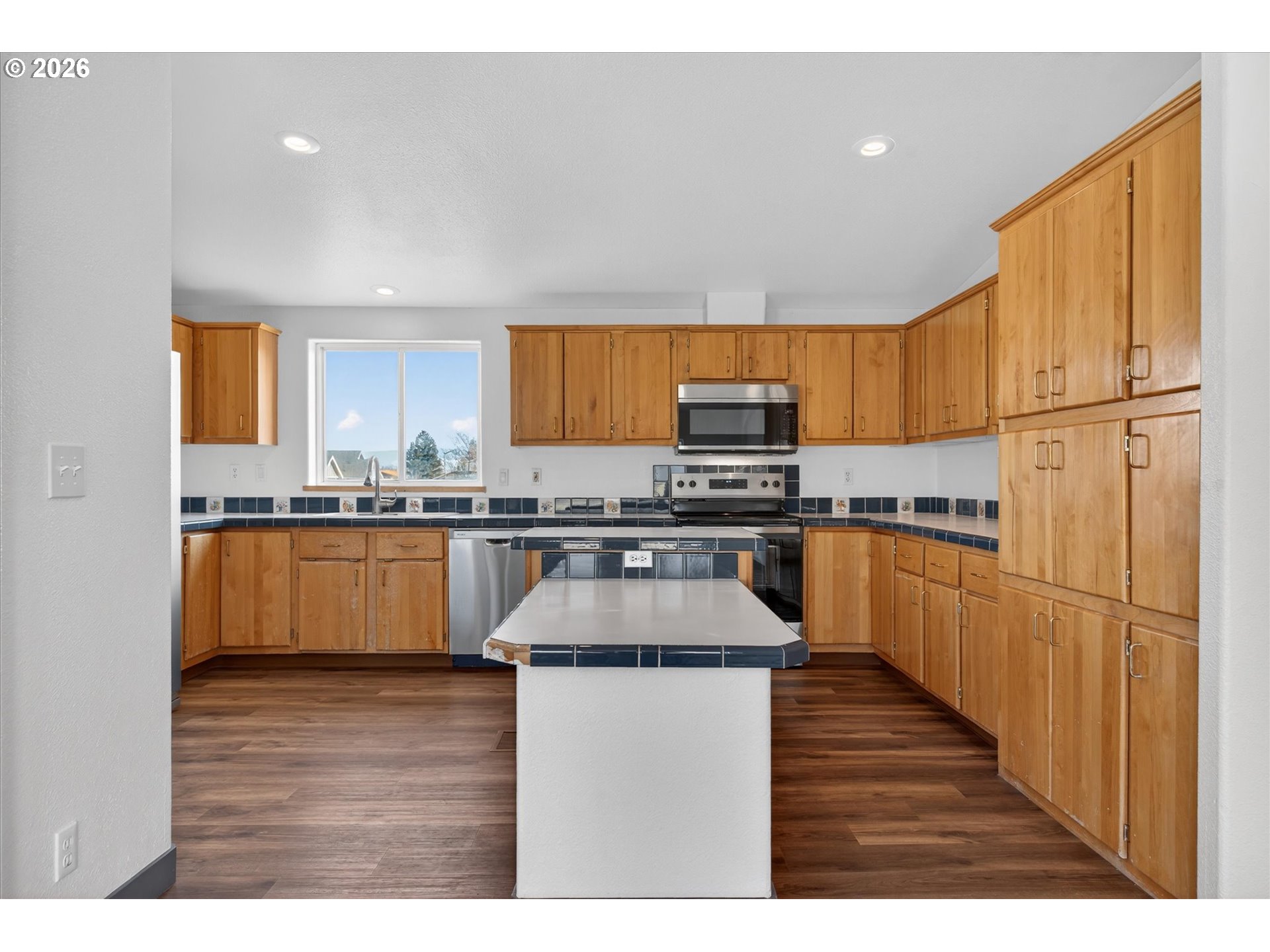 208 16th Street La Grande, OR 97850 - Photo 11 of 42 a kitchen with stainless steel appliances granite countertop a stove a sink and a refrigerator