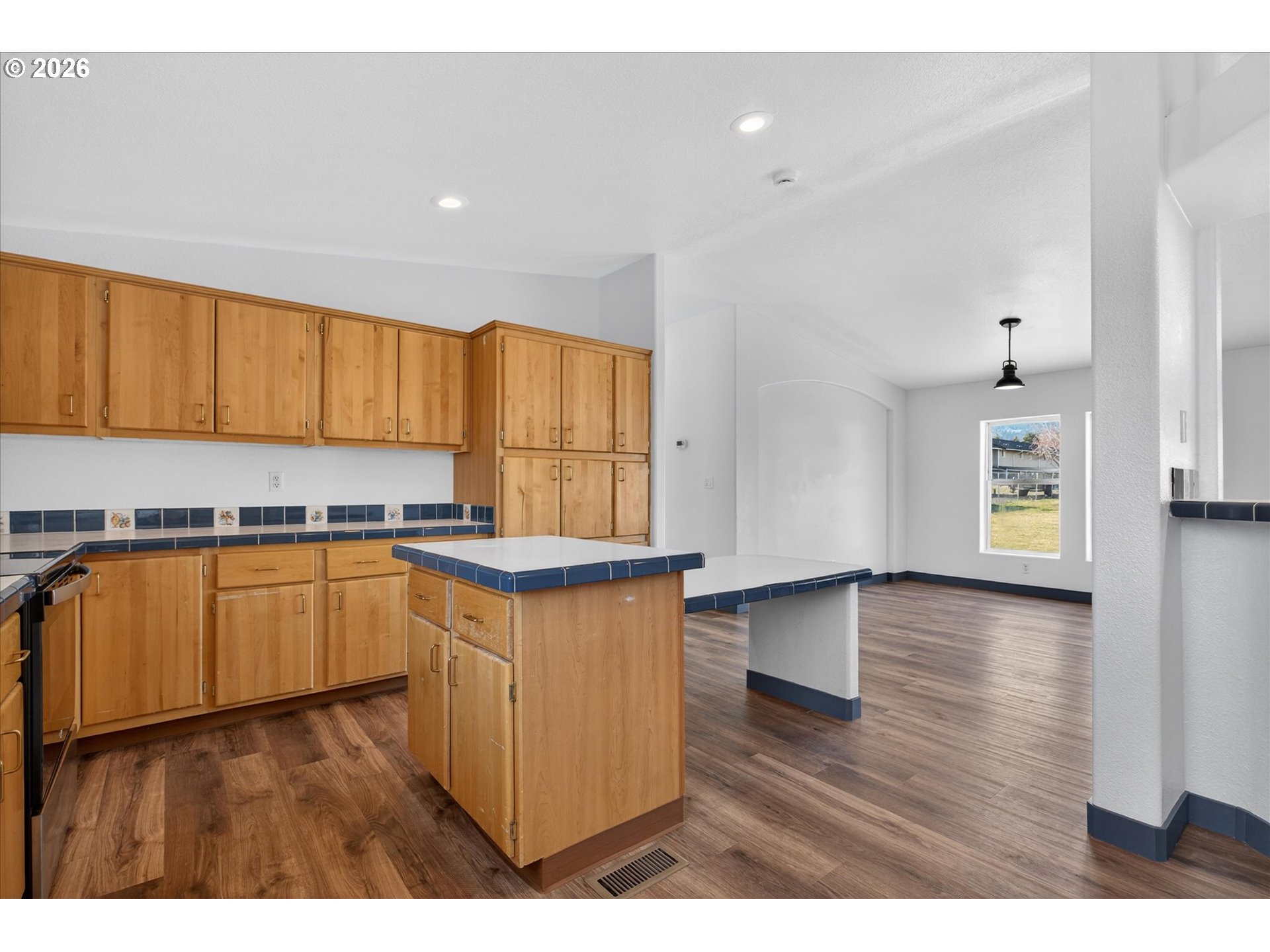 208 16th Street La Grande, OR 97850 - Photo 13 of 42 a kitchen with stainless steel appliances granite countertop a stove a sink dishwasher and a microwave with wooden floor