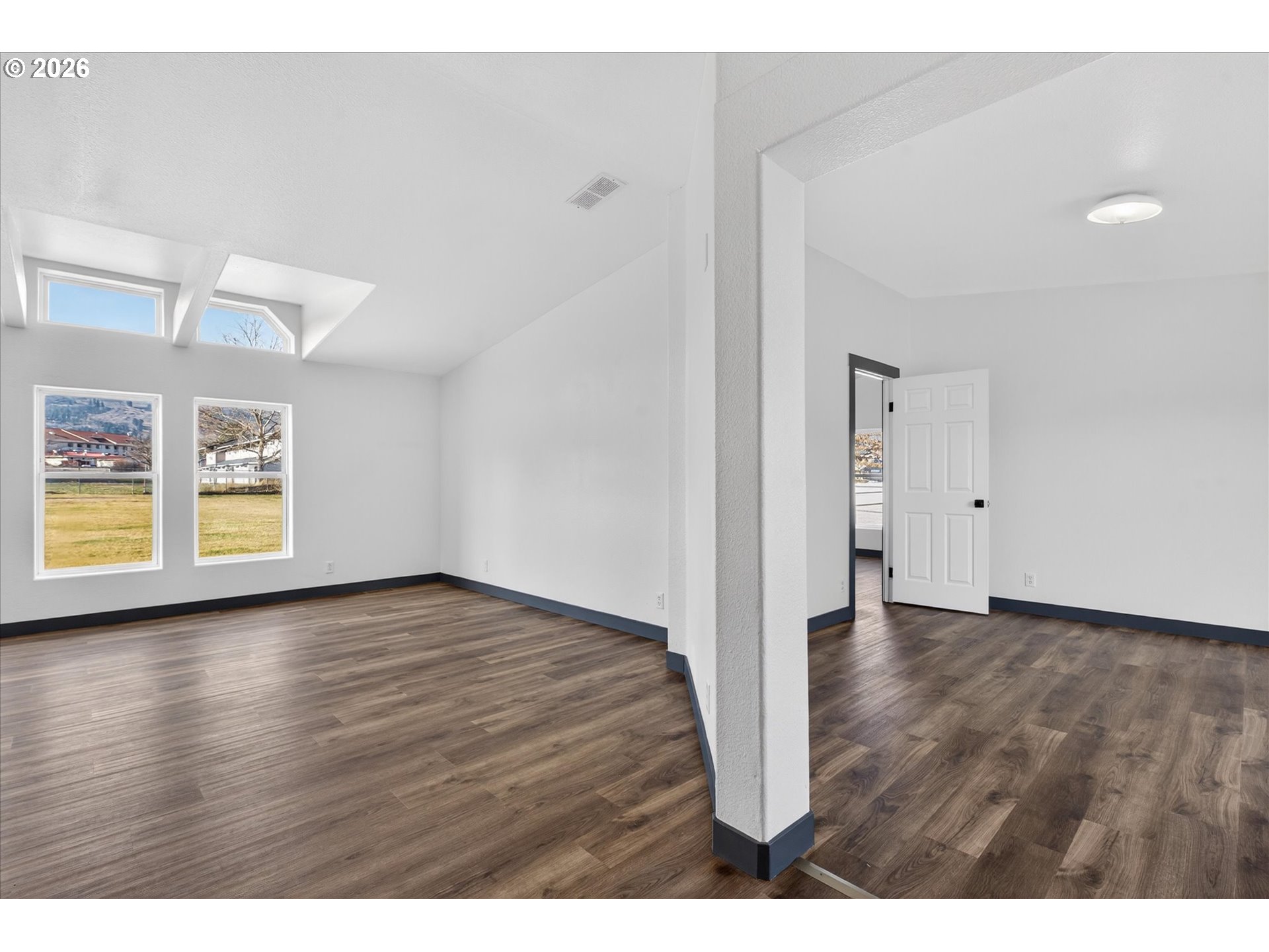 208 16th Street La Grande, OR 97850 - Photo 15 of 42 a view of an empty room with wooden floor and a window