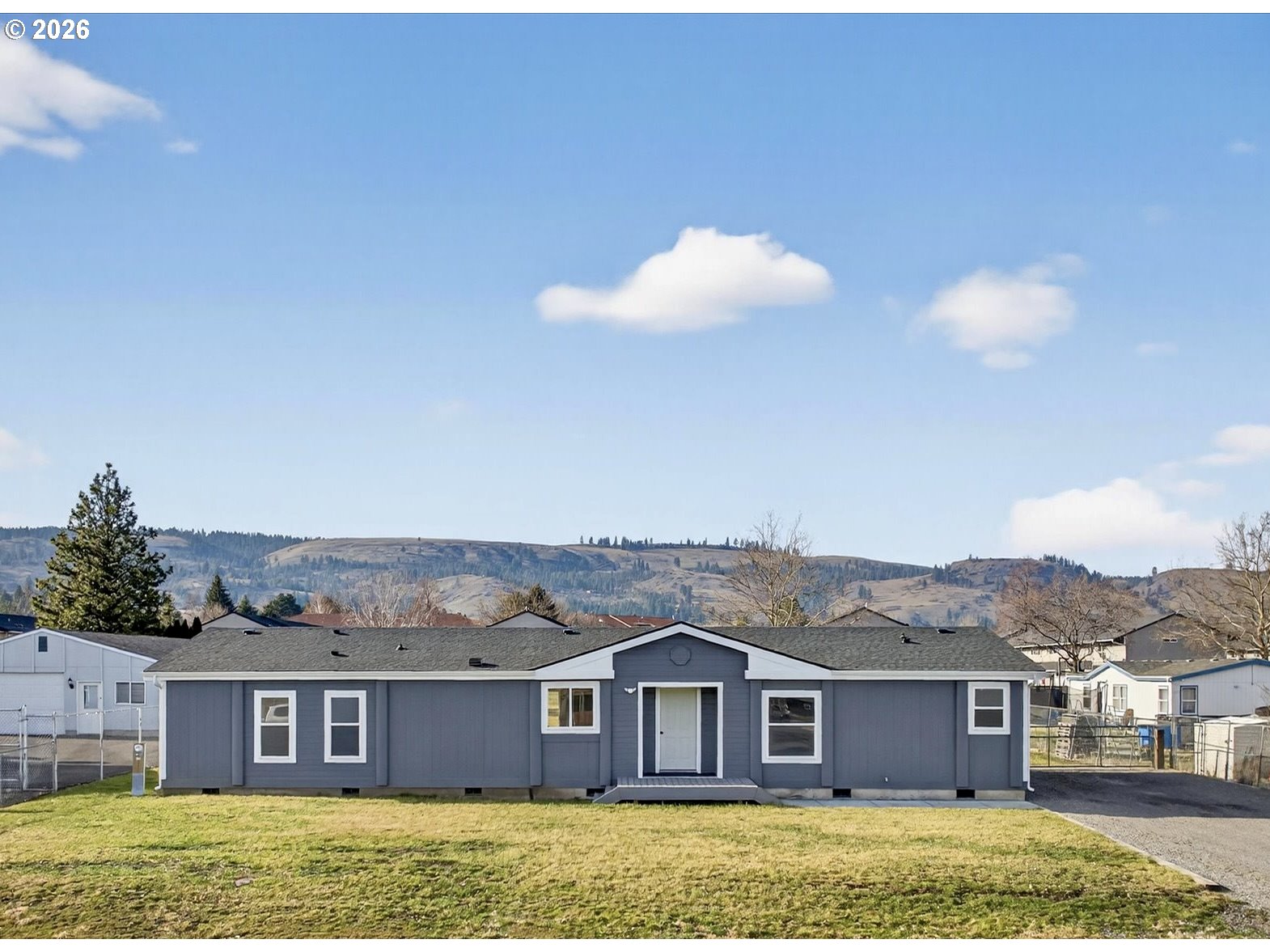 208 16th Street La Grande, OR 97850 - Photo 2 of 42 a view of a house with a backyard