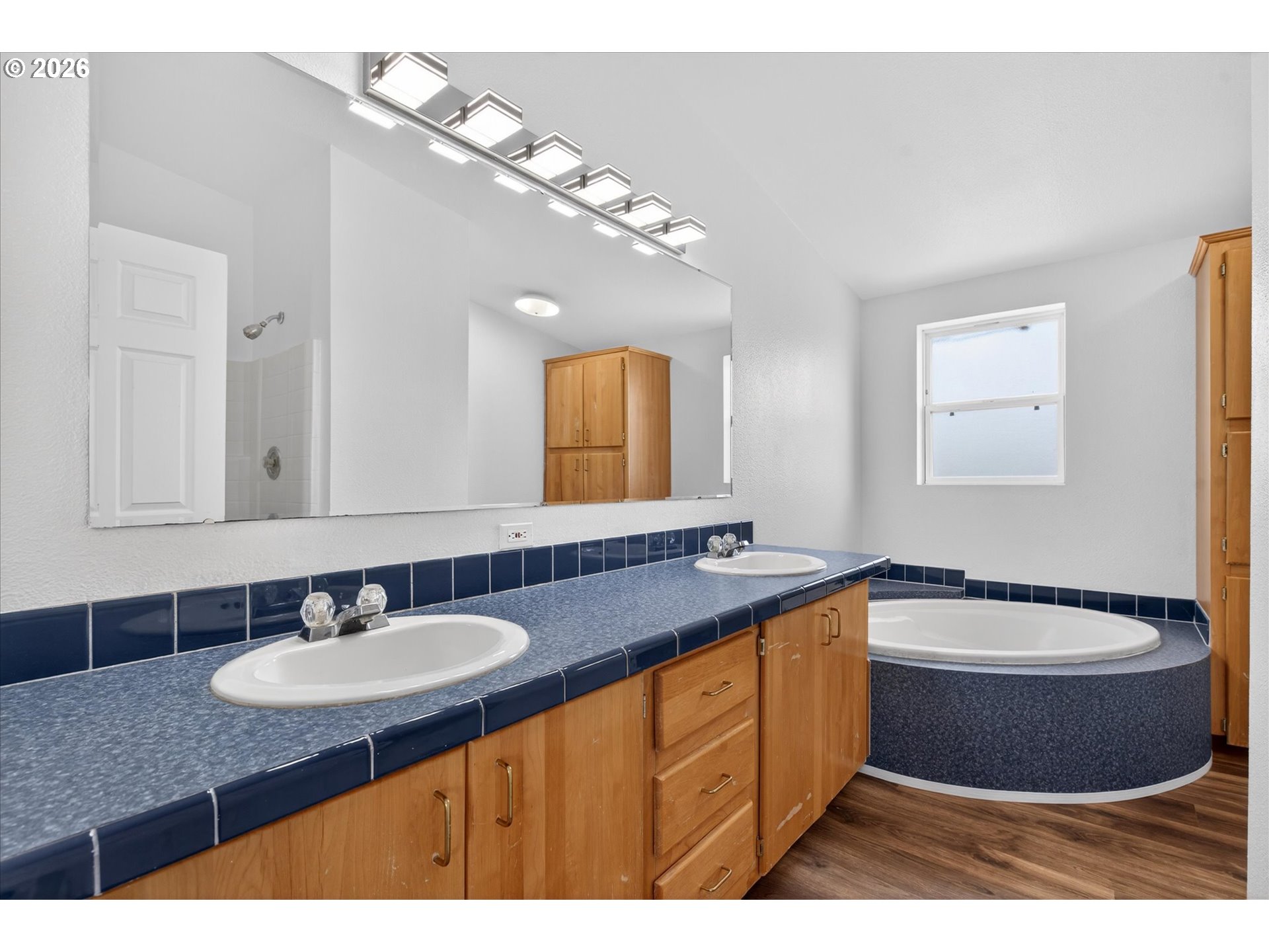 208 16th Street La Grande, OR 97850 - Photo 21 of 42 a bathroom with a granite countertop sink a mirror and bathtub