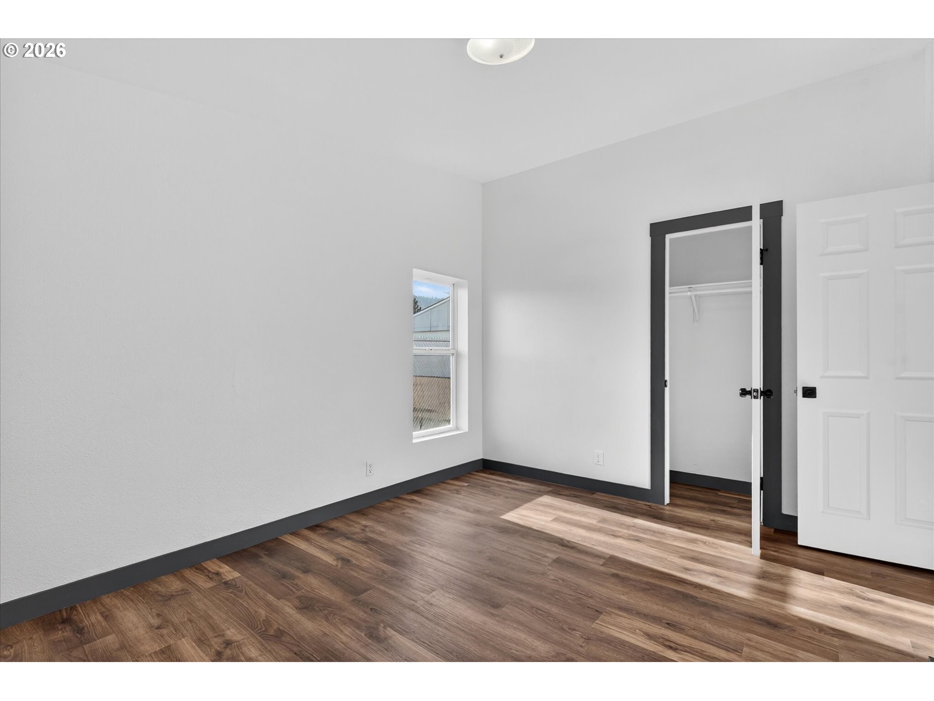 208 16th Street La Grande, OR 97850 - Photo 27 of 42 a view of an empty room with wooden floor