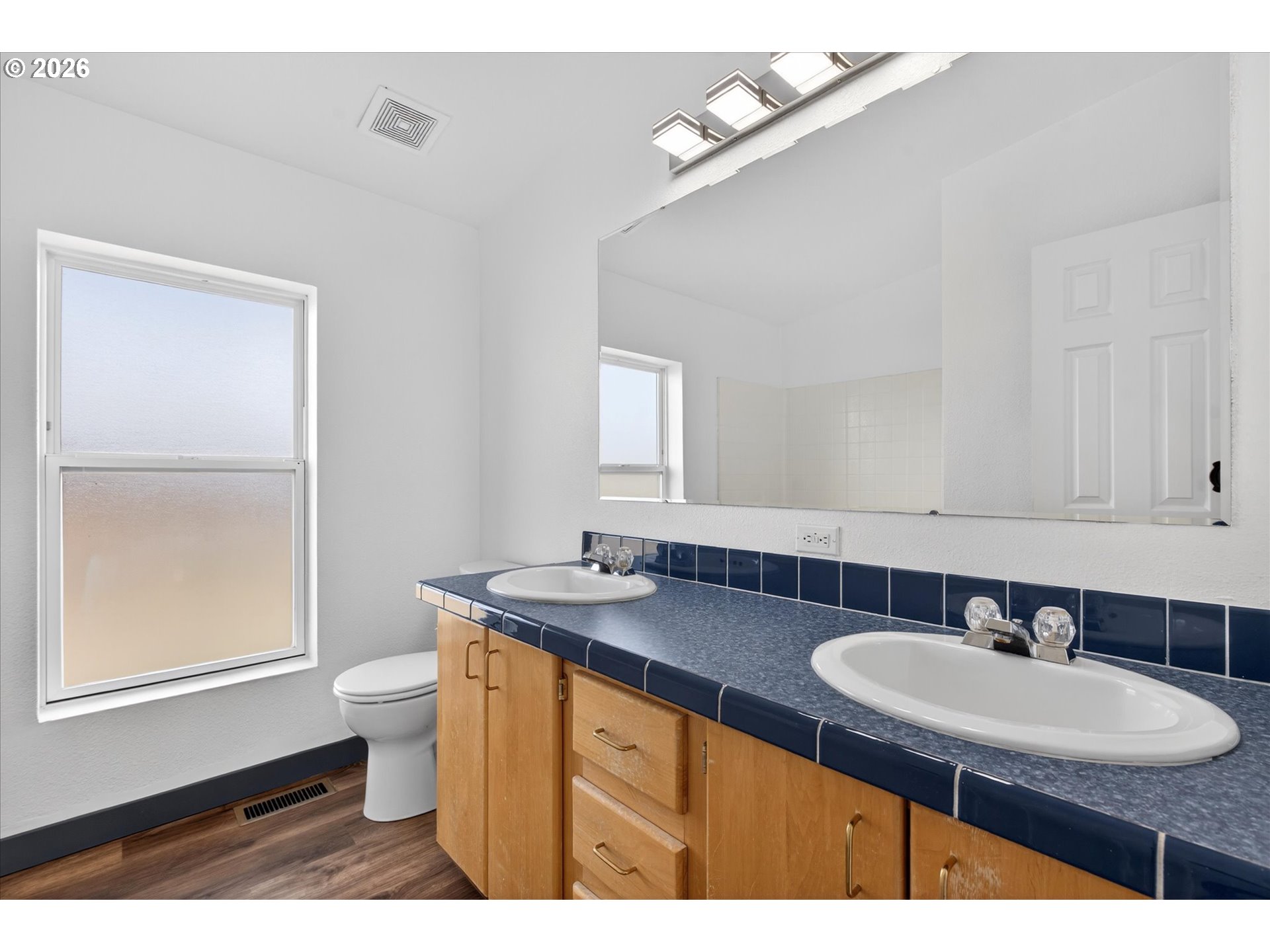 208 16th Street La Grande, OR 97850 - Photo 28 of 42 a bathroom with a sink double vanity granite and a mirror