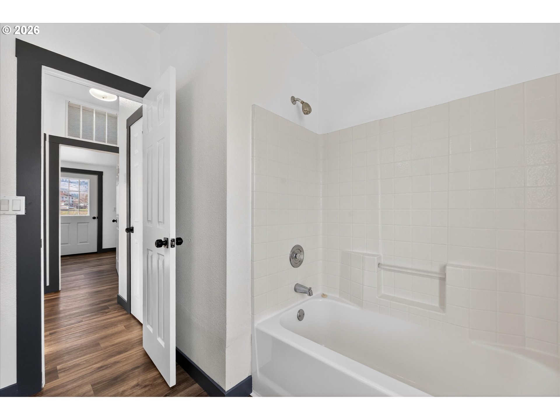 208 16th Street La Grande, OR 97850 - Photo 29 of 42 a bathroom with a tub shower and a sink